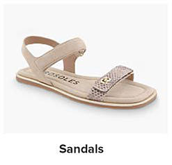 A pair of beige Aerosoles sandals. Shop sandals.