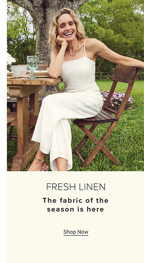 An image of a woman wearing a white jumpsuit. Fresh linen. The fabric of the season is here. Shop now.