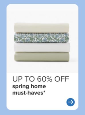 A stack of folded sheets. Up to 60% off spring home must haves.