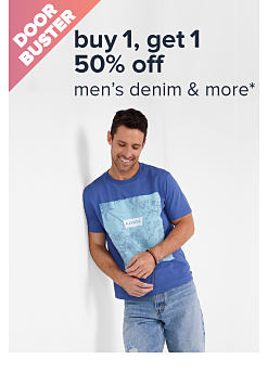 Doorbuster. An image of a man wearing a blue graphic shirt and jeans. Buy 1, get 1 50% off men's denim and more. 