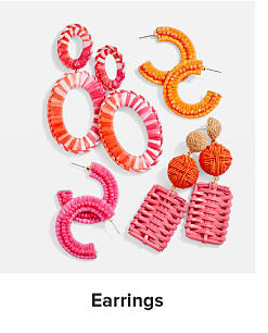 Assortment of pink, red and orange statement earrings. Shop earrings.