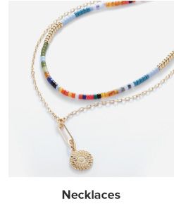Image of a dainty gold necklace and colorful beaded necklace. Shop necklaces