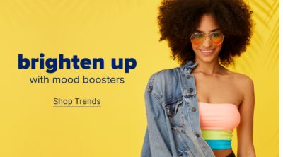 A woman wearing a strapless top featuring horizontal stripes in coral, green and blue. She wears a denim jacket over one shoulder. Brighten up with mood boosters. Shop trends.