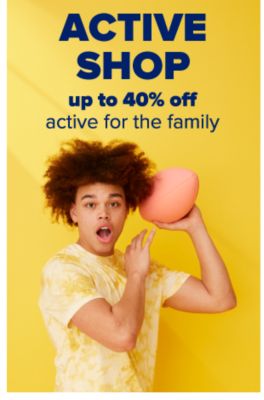 A young man wearing a yellow tie-dye top and throwing a football. Active Shop. Up to 40% off active for the family.