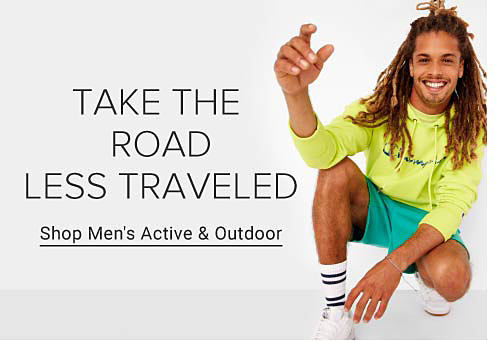 Man wearing a yellow hoodie, green shorts and white sneakers. Take the road less traveled. Shop men's active and outdoor.