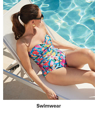 An image of a woman wearing a swimsuit by a pool. Shop swimwear.
