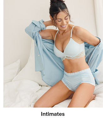 An image of a woman wearing a bra and panty set. Shop intimates.