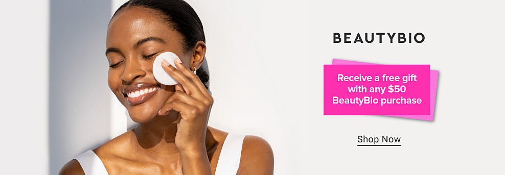 Image of a woman wiping her face with a cotton round. BeautyBio logo. Receive a free gift with any $50 BeautyBio purchase. Shop now.