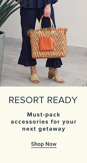 An image featuring a woman wearing resort apparel and carrying a woven handbag. Resort ready. Must pack accessories for your next getaway. Shop now.