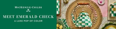 The MacKenzie Childs logo. Meet Emerald Check. A luxe pop of color. An image of a tea kettle on a placemat next to an assortment of MacKenzie Childs products.