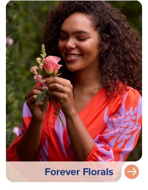 Image of a woman wearing a red and purple floral dress. Forever florals.