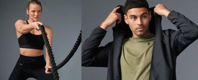 A woman in black activewear doing a ropes exercise. A man in an olive tee putting his gray hoodie up. Under Armour.