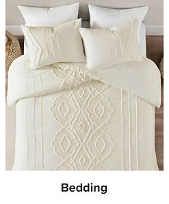 A bed with white textured bedding. Shop bedding.