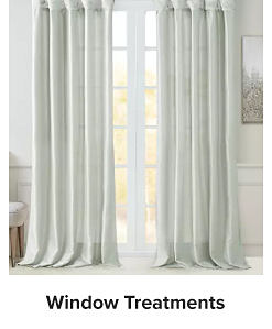 A window with curtains. Shop window treatments.