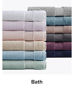 A stack of towels in an assortment of colors. Shop bath. 