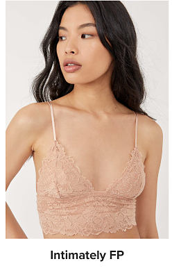 A woman wearing a light pink bralette. Shop Intimately FP.