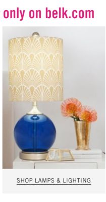 A blue glass lamp with a beige shade. Shop lamps and lighting.