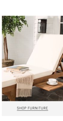 An wooden lounge chair with a white cushion. Shop furniture.
