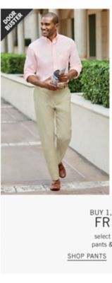 A man wearing a light pink dress shirt and khakis. Door buster. From 24.99 men's pants. Shop pants.