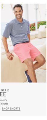 A man wearing a gray sport polo and light pink shirt. From 24.99 men's shorts. Shop shorts.