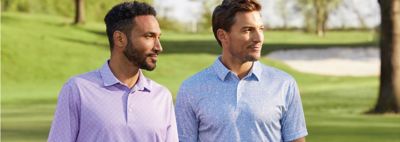 An image of two men at a golf course wearing polo shirts.