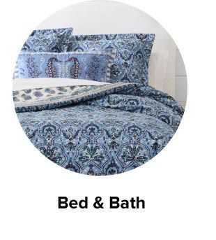 An image of a bed with printed bedding. Bed and bath.