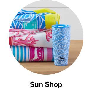 An image of beach towels and a drink tumbler. Sun shop.
