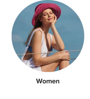 An image of a woman wearing a white outfit and a pink sun hat. Shop women. 