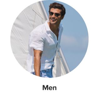 An image of a man wearing a white polo and sunglasses. Shop men. 