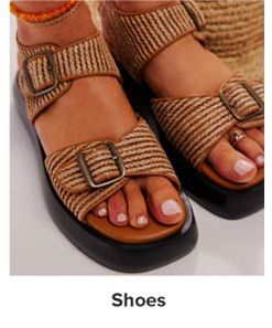 Image of brown strappy sandals. Shop shoes.