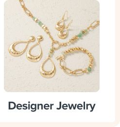A gold pendant, earrings and bracelet. Designer jewelry.