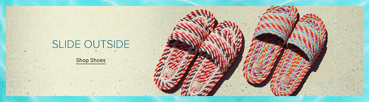 Two pairs of flat slide sandals featuring a colorful woven design. Slide outside. Shop shoes.