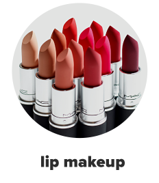 Various shades of red and pink lipsticks, caps off to show the colors. Lip makeup. 