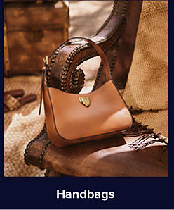 A brown leather handbag. Handbags. 