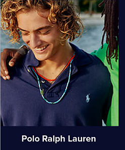 A man wears a blue Polo Ralph Lauren polo shirt. Polo Ralph Lauren. 