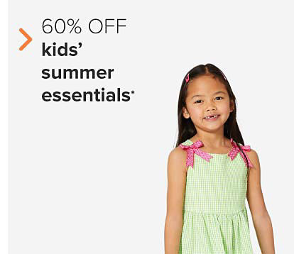 A girl in a green dress with pink ribbons on the shoulders. 60% off kids' summer essentials. 