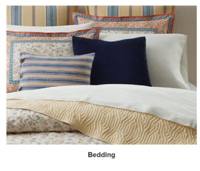 A bedding set with blue and red accents. Bedding.