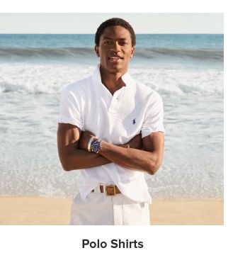 A man in a white polo on the beach. Polo shirts.