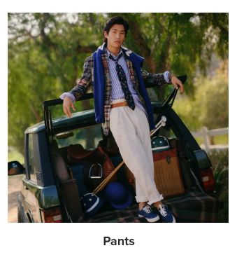 A man in a variety of Ralph Lauren clothing and khaki pants, standing on a tailgate. Pants.