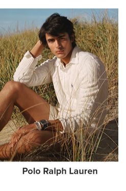 A man in a white shirt on the beach. Polo Ralph Lauren.
