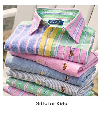 A stack of brightly colored kids' button up shirts. Gifts for kids.
