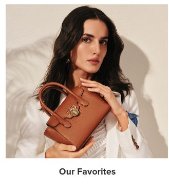 A woman holding a brown handbag. Our Favorites.