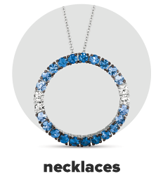 A necklace with a circle pendant accented by blue and white diamonds. Shop necklaces.