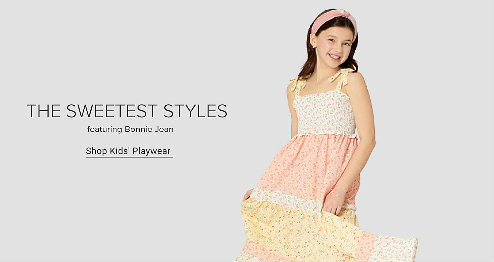 Girl wearing pink, yellow and white floral dress. The sweetest styles featuring Bonnie Jean. Shop kids' playwear.