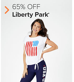 A woman in a white sleeveless top with an American flag on it and blue pants with USA running up the side. 65% off Liberty Park. 
