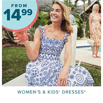 From 14.99 women's and kids' dresses. A woman in a blue and white dress. 
