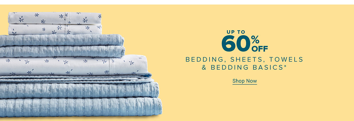 A pile of folded blue bedding. Up to 60% off bedding, sheets, towels and bedding basics. Shop Now.