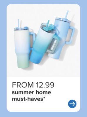 A green beach bag filled with beach towels and a big aluminum mug. From 12.99 summer home must haves.