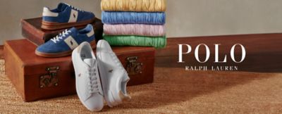 Blue and white sneakers displayed with folded colorful shirts on wooden trunk. Polo Ralph Lauren. 