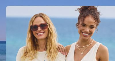 An image of two women at the beach wearing stylish summer apparel.